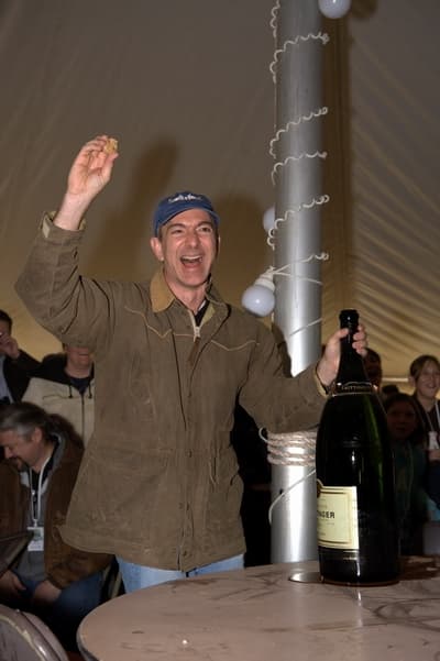 Blue Origin founder Jeff Bezos pops a large bottle of champagne at the Goddard launch.