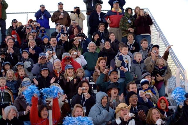 Blue Origin employees, their families, and guests cheer from bleachers as they watch Goddard’s launch.