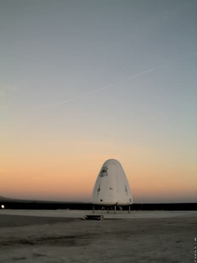 Goddard, the first development vehicle in the New Shepard program, sits on the landing pad during sunrise.