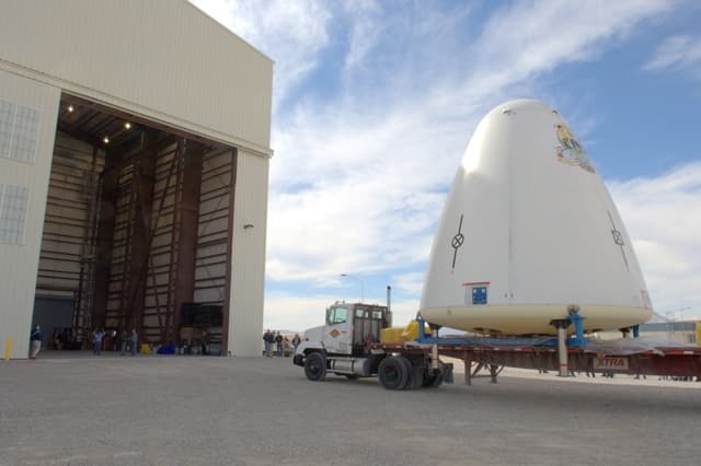 Goddard, the first development vehicle in the New Shepard program, is transported on a truck.