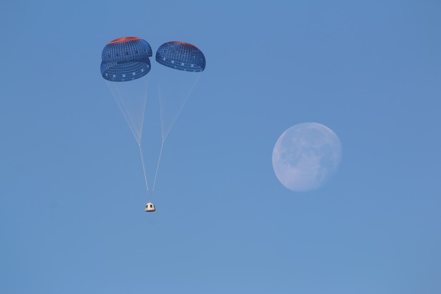 New Shepard's crew capsule descends under parachutes.