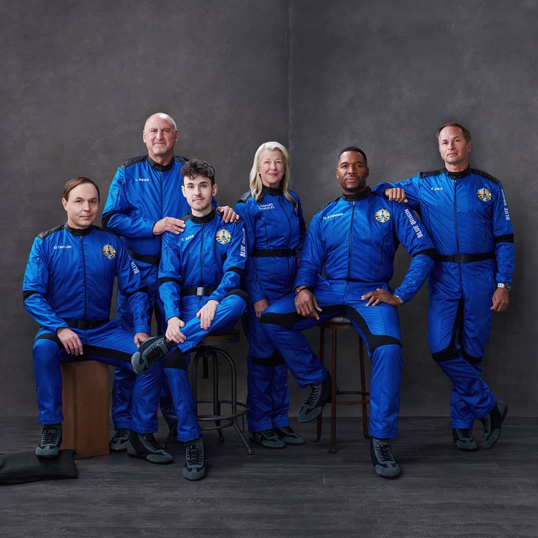 The NS-19 crew poses for their official portrait wearing blue flight suits.