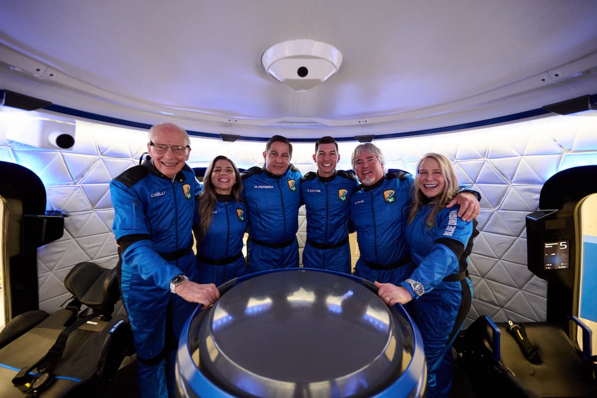 The NS-22 crew poses inside the crew capsule mock-up in the Astronaut Training Center.