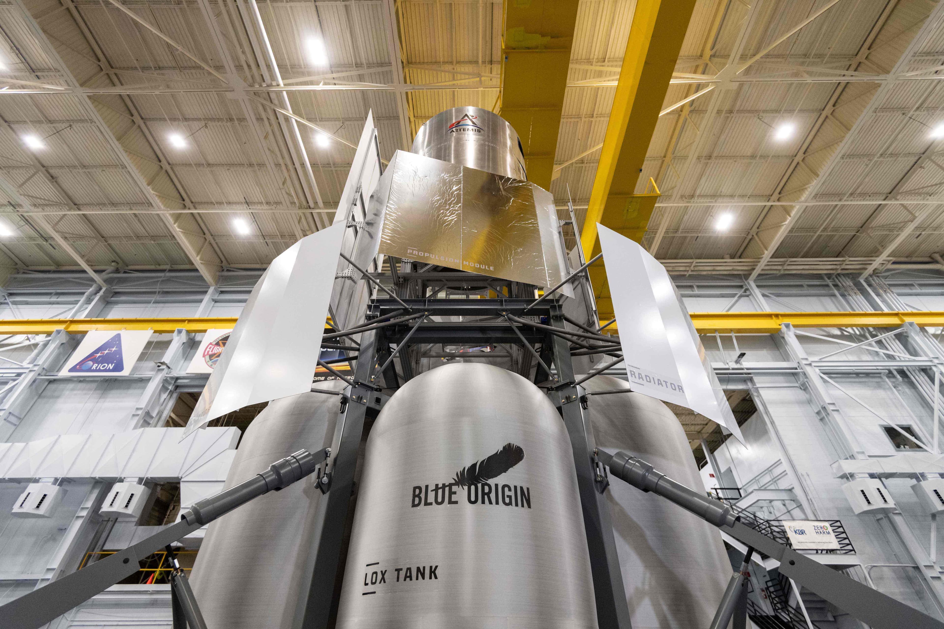 A close-up view of a full-scale engineering mock-up of a lunar crew lander vehicle sitting inside a warehouse.