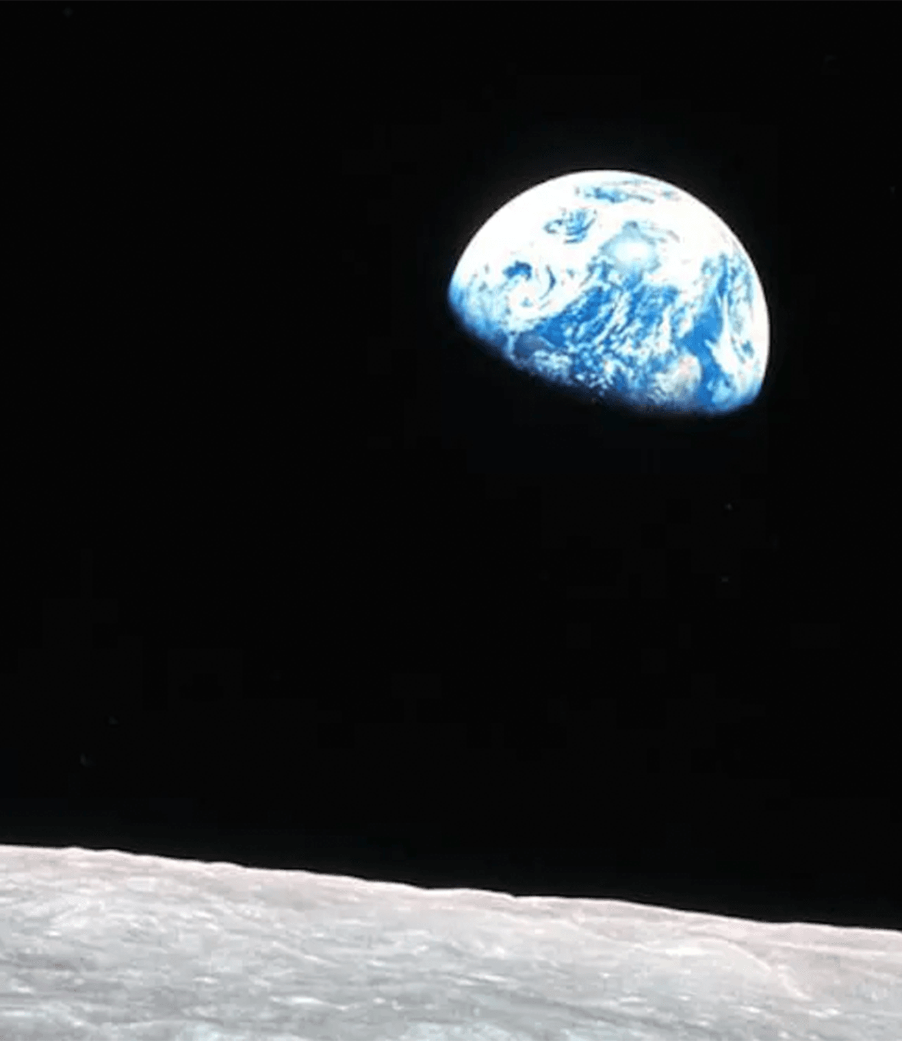 Part of planet Earth, with visible white clouds and blue oceans, visible against the black background of space, as seen from the Moon.