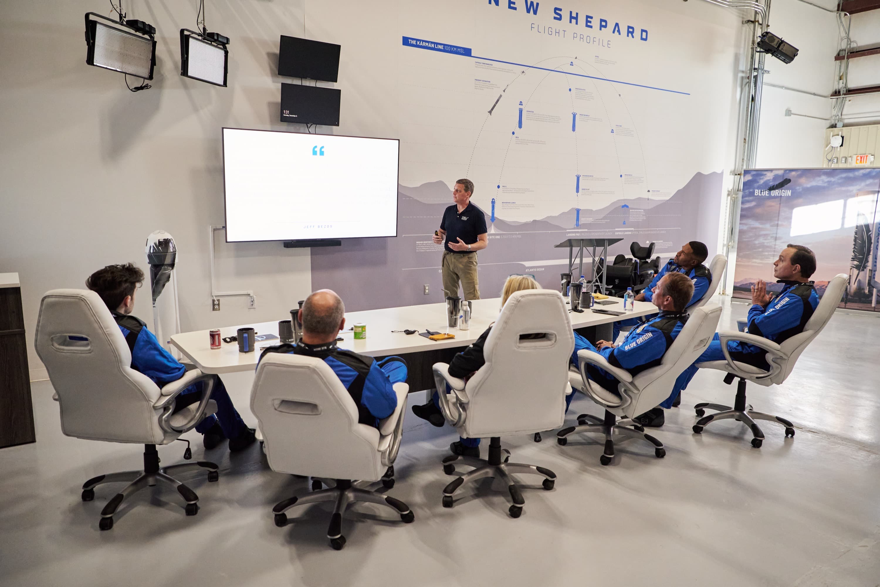 The NS-19 crew listens to CrewMember7 during training in the Astronaut Training Center.