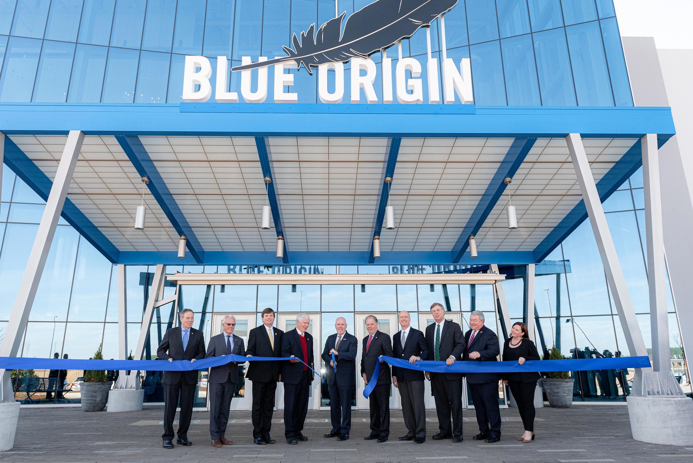 CEO Bob Smith and local leaders pose during a ribbon-cutting ceremony in front of Blue Origin’s rocket engine production facility in Huntsville, AL.