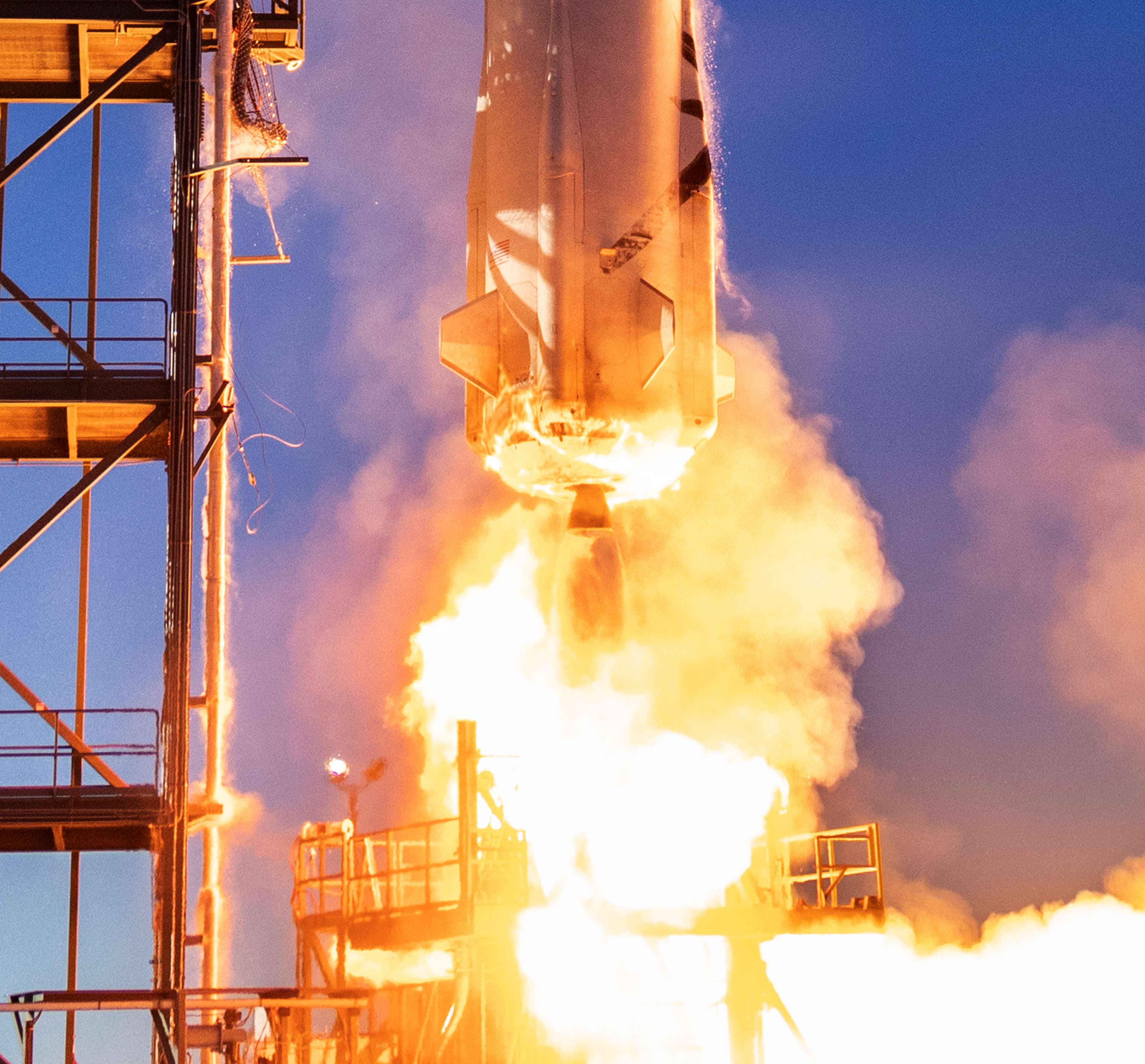 A bright flame from the BE-3 engine as New Shepard lifts off.