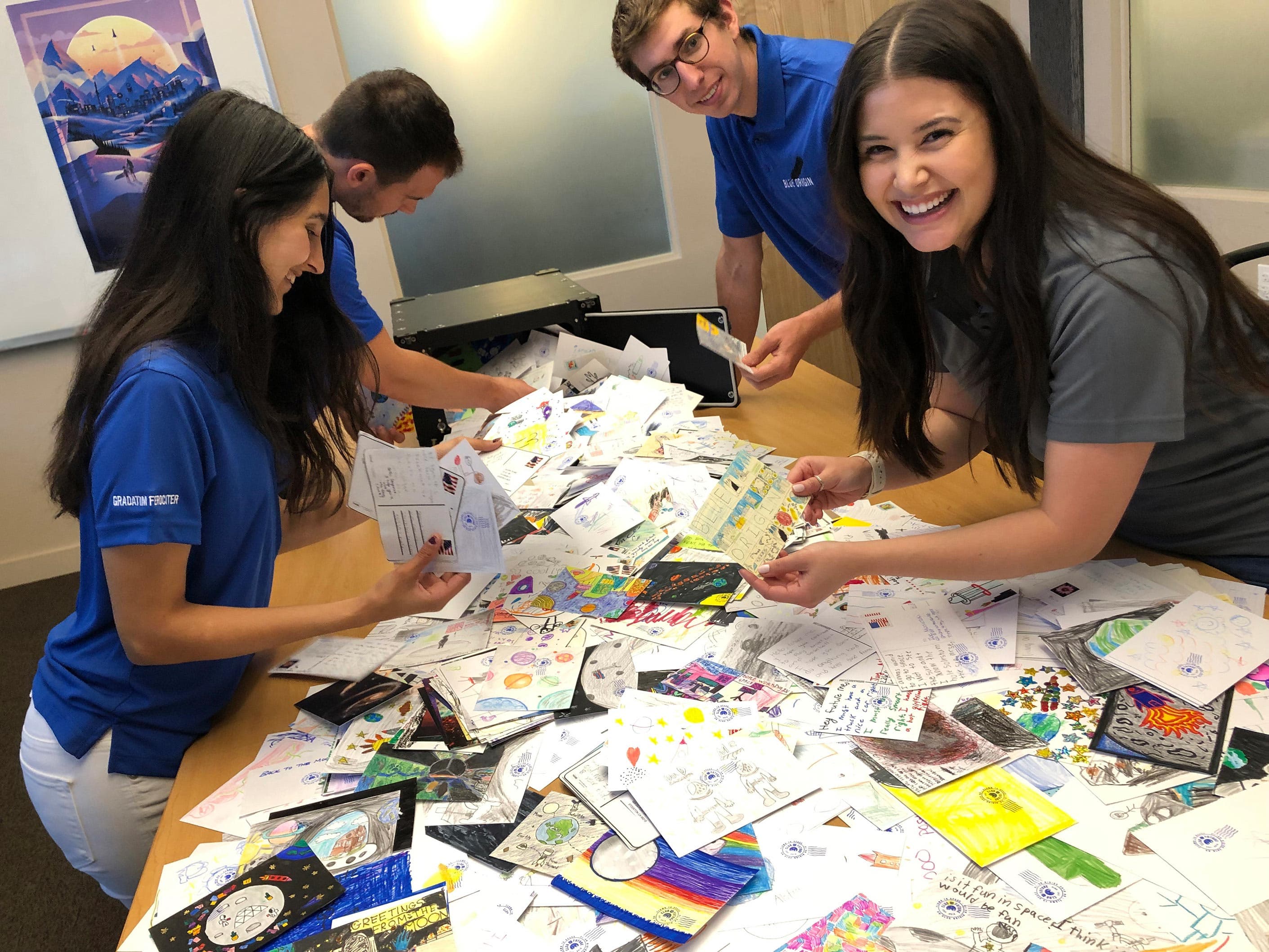 Blue Origin employees sort Club for the Future postcards that will fly to space on New Shepard.