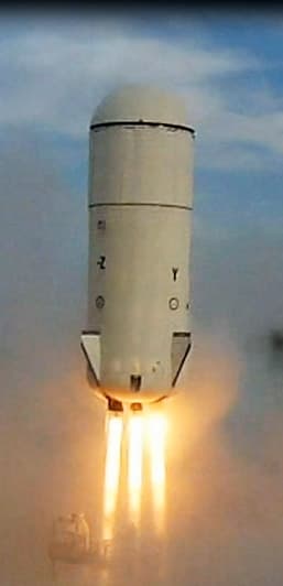 Goddard launches for the first time, soaring towards space with blue sky barely visible in the background.