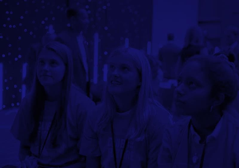 Three girls with Club for the Future t-shirts